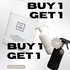Promotional graphic showing a large white plastic bottle labelled Lavender All Purpose Cleaner, a smaller white spray bottle, and a black spray bottle with large overlaid text reading 'BUY 1 GET 1' and a gray 'OR' badge on a light background.