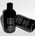 Two black bottles of Só Soap hand wash concentrates, one standing upright and the other lying on its side, on a white background.