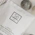 Só Clean oxygen whitening powder packaging with felt dryer balls on a neutral surface.